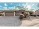 This home features a two-car garage and desert landscaping at 18193 W Buckhorn Dr, Goodyear, AZ 85338