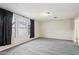 Primary bedroom with neutral walls and carpet, and window at 18536 W Douglas Way, Surprise, AZ 85374