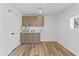 Bright laundry room with wood cabinets and new flooring at 1890 E Palmcroft Dr, Tempe, AZ 85282