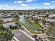 Scenic aerial view of a residential neighborhood featuring lakes, green spaces, and mature trees at 1923 E Drake Dr, Tempe, AZ 85283