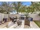 Outdoor living space featuring an outdoor grill, fire pit, and comfortable seating amidst a private yard at 1923 E Drake Dr, Tempe, AZ 85283