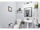 Charming half-bathroom featuring an undermount sink, pedestal sink, and stylish decor at 1923 E Drake Dr, Tempe, AZ 85283