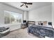 Cozy bedroom featuring a ceiling fan, large window, and a functional desk and workstation at 1923 E Drake Dr, Tempe, AZ 85283