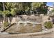 The Oasis community entrance featuring a stone sign, waterfall, and lush landscaping at 1923 E Drake Dr, Tempe, AZ 85283