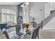 Bright dining room with a modern glass table, complemented by a staircase and stylish decor at 1923 E Drake Dr, Tempe, AZ 85283