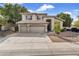 Elegant two-story home featuring a tile roof, three-car garage, and meticulously landscaped front yard at 1923 E Drake Dr, Tempe, AZ 85283