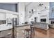 Open kitchen featuring granite countertops, barstool seating, and views into the living area at 1923 E Drake Dr, Tempe, AZ 85283
