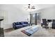 Spacious living room featuring a blue sofa, gaming area, and sliding glass doors for natural light at 1923 E Drake Dr, Tempe, AZ 85283