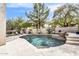 Beautiful backyard pool featuring a unique stone waterfall feature, lush landscaping, and seating area at 1923 E Drake Dr, Tempe, AZ 85283