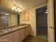 Bathroom with double sinks, granite countertop and access to bedroom at 2332 E Nora St, Mesa, AZ 85213