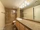 Bathroom with granite countertop, updated vanity, and shower at 2332 E Nora St, Mesa, AZ 85213