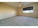 Well-lit bedroom with neutral carpeting and large window at 2332 E Nora St, Mesa, AZ 85213