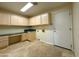 Laundry room with built-in cabinets and countertop workspace at 2332 E Nora St, Mesa, AZ 85213