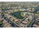 An aerial view of a beautiful community with tree-lined streets and lakes at 2338 N 112Th Ln, Avondale, AZ 85392