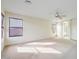 Spacious bedroom features neutral carpet, a ceiling fan, and lots of natural light at 2338 N 112Th Ln, Avondale, AZ 85392