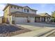 Charming two-story home featuring a three-car garage and desert landscaping at 2338 N 112Th Ln, Avondale, AZ 85392
