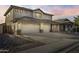 Charming two-story home featuring a three-car garage and desert landscaping at 2338 N 112Th Ln, Avondale, AZ 85392