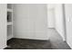 Upper hallway features gray carpet flooring, white trim and a glimpse into another room at 2338 N 112Th Ln, Avondale, AZ 85392
