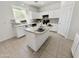 This kitchen boasts white cabinets, an island, neutral countertops, and stainless steel appliances at 2338 N 112Th Ln, Avondale, AZ 85392