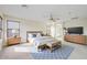 Staged primary bedroom featuring carpeted floors, a ceiling fan, and lots of natural light at 2338 N 112Th Ln, Avondale, AZ 85392