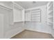 Spacious walk-in closet with built-in shelving and carpet flooring at 2338 N 112Th Ln, Avondale, AZ 85392