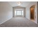 Spacious bedroom with large window and neutral wall colors at 24201 W Lasso Ln, Buckeye, AZ 85326