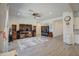 Bright living room featuring hardwood floors and large TV at 24393 N 169Th Dr, Surprise, AZ 85387