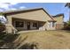 Home's backyard with covered patio and grassy area at 25671 W Miami St, Buckeye, AZ 85326