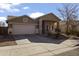 House exterior features a two-car garage and desert landscaping at 25671 W Miami St, Buckeye, AZ 85326