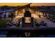 Night view of a community clubhouse with a large fire pit and seating area at 26128 S 228Th Pl, Queen Creek, AZ 85142