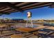 Covered patio area with picnic tables near water feature at 26128 S 228Th Pl, Queen Creek, AZ 85142