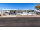 Gray manufactured home with carport, ramp, and small patio at 2650 W Union Hills Dr # 231, Phoenix, AZ 85027