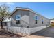Gray mobile home with multiple windows and carport at 2650 W Union Hills Dr # 231, Phoenix, AZ 85027