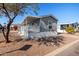 Gray mobile home with covered porch and landscaping at 2650 W Union Hills Dr # 231, Phoenix, AZ 85027