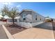 Gray mobile home with carport and ramp access at 2650 W Union Hills Dr # 231, Phoenix, AZ 85027