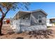 Gray mobile home with covered porch and lattice at 2650 W Union Hills Dr # 231, Phoenix, AZ 85027