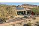 Home with solar panels, a pool and a desert landscape, in the background at 3021 W Feather Sound Dr, Phoenix, AZ 85086