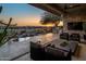 Tranquil patio scene at sunset, featuring comfortable seating and a fire pit at 3021 W Feather Sound Dr, Phoenix, AZ 85086