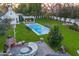 Aerial view of a backyard featuring a pool, fireplace, patio seating and guest house at 3048 N 45Th St, Phoenix, AZ 85018