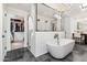 Elegant bathroom featuring a modern tub, glass-enclosed shower, and stylish chandelier at 3048 N 45Th St, Phoenix, AZ 85018