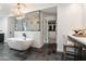 Bright bathroom with a standalone tub, a glass-enclosed shower, and a vanity area at 3048 N 45Th St, Phoenix, AZ 85018