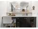 Bathroom vanity area featuring dual mirrors, marble countertop, dark wood cabinets, and a chair at 3048 N 45Th St, Phoenix, AZ 85018