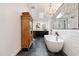 Bathroom with a standalone tub, a walk-in shower, and a vanity, accented by a chandelier at 3048 N 45Th St, Phoenix, AZ 85018
