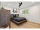 Bedroom with wooden floors, a wooden bed frame, and bright natural light from window at 3048 N 45Th St, Phoenix, AZ 85018