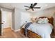 Comfortable bedroom featuring wood floors, ceiling fan, and a decorative wooden bed frame at 3048 N 45Th St, Phoenix, AZ 85018