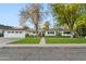 Charming single-story home featuring a lush front lawn, brick walkway, and a two-car garage at 3048 N 45Th St, Phoenix, AZ 85018