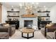 Stylish living room with fireplace, wooden mantel, built-in shelves, cabinets, and elegant chandelier at 3048 N 45Th St, Phoenix, AZ 85018
