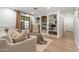 Cozy living room with a large window, built-in bookshelves, and neutral-toned furniture at 3048 N 45Th St, Phoenix, AZ 85018
