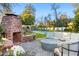 Outdoor living space featuring a brick fireplace and comfortable seating near the pool at 3048 N 45Th St, Phoenix, AZ 85018