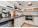 Pantry with white cabinets, open shelving, ample counter space, and stainless steel appliances at 3048 N 45Th St, Phoenix, AZ 85018